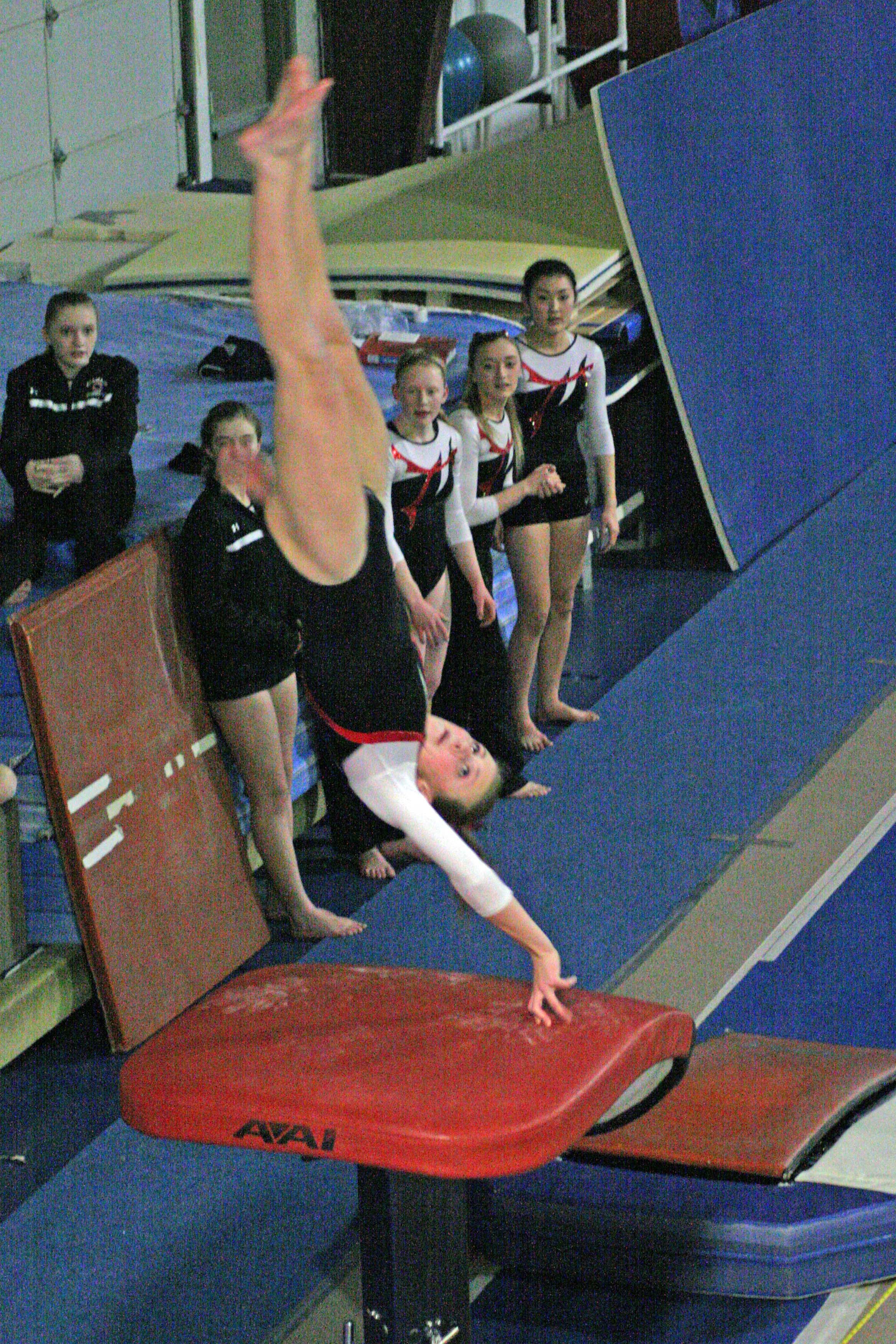 Caleigh Lofstead presses off the vault and lands in fourth place for the Papermakers with a score of 8.95.