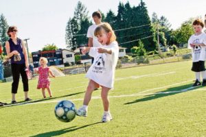 Attendees practice shooting the ball during a Soccer Stars of Tomorrow camp last summer.