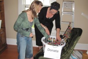 Professional organizer Krista Colvin (right) helps Jamie Twyman organize a room so she can offer in-home massage therapy.   Colvin said that when people are organized, they feel more in control of their lives because their "stuff" isn't controlling them.