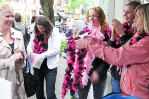 Members of the Camas High School girls' basketball team supplied pink boas for women who successfully made "baskets" into a trash container.
