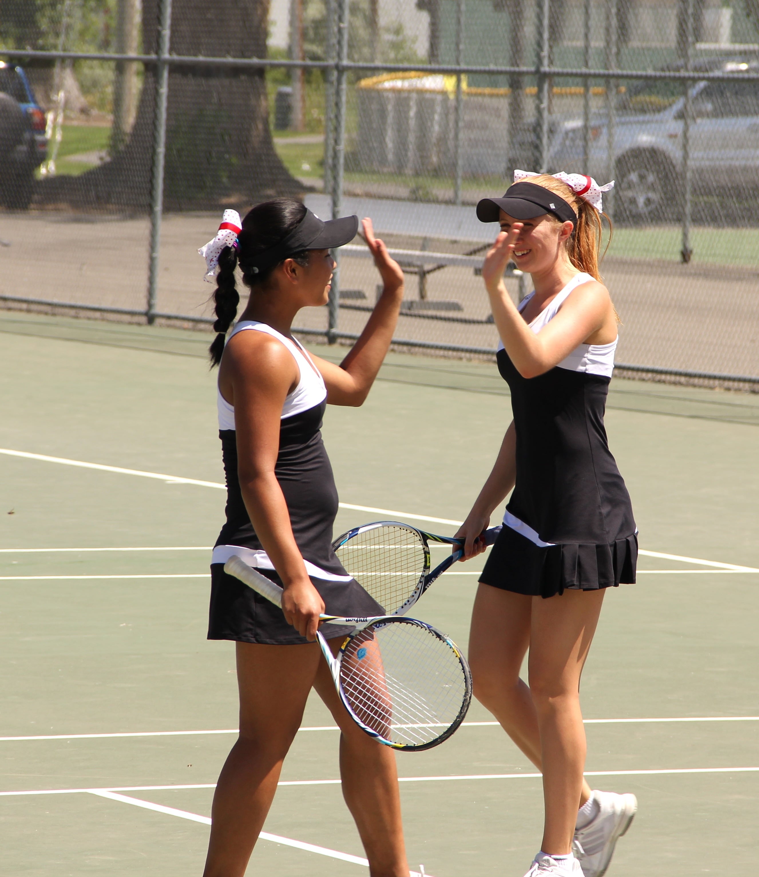 Hannah Gianan and Jen Lewis celebrate after scoring a point for the Papermakers.