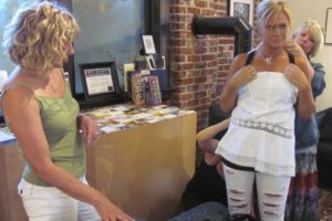 Gwen Johnson (left), of Washougal, observes Liz Nye (right), of Camas, adding a necklace to a model's outfit. Johnson, Nye and Jeanne Jennings (not pictured), of Camas, will participate in the "Not Your Mother's Fashion Show," Saturday, Aug. 7, at 11 a.m., at the Sixth Street Gallery, in downtown Vancouver.