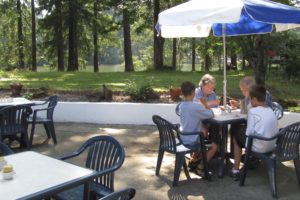 Cissy Sanders and Terry Daenzer, of Ryderwood, enjoy a brownie treat, strawberry milkshake and orange float with their grandsons Nate and Bryce Anderson, of Hockinson, on the patio overlooking Lacamas Lake, at Lakeside Chalet restaurant, in Camas. Restaurant owners Nick and Paula Stanley plan to host a 30-year business anniversary barbecue later this summer.
