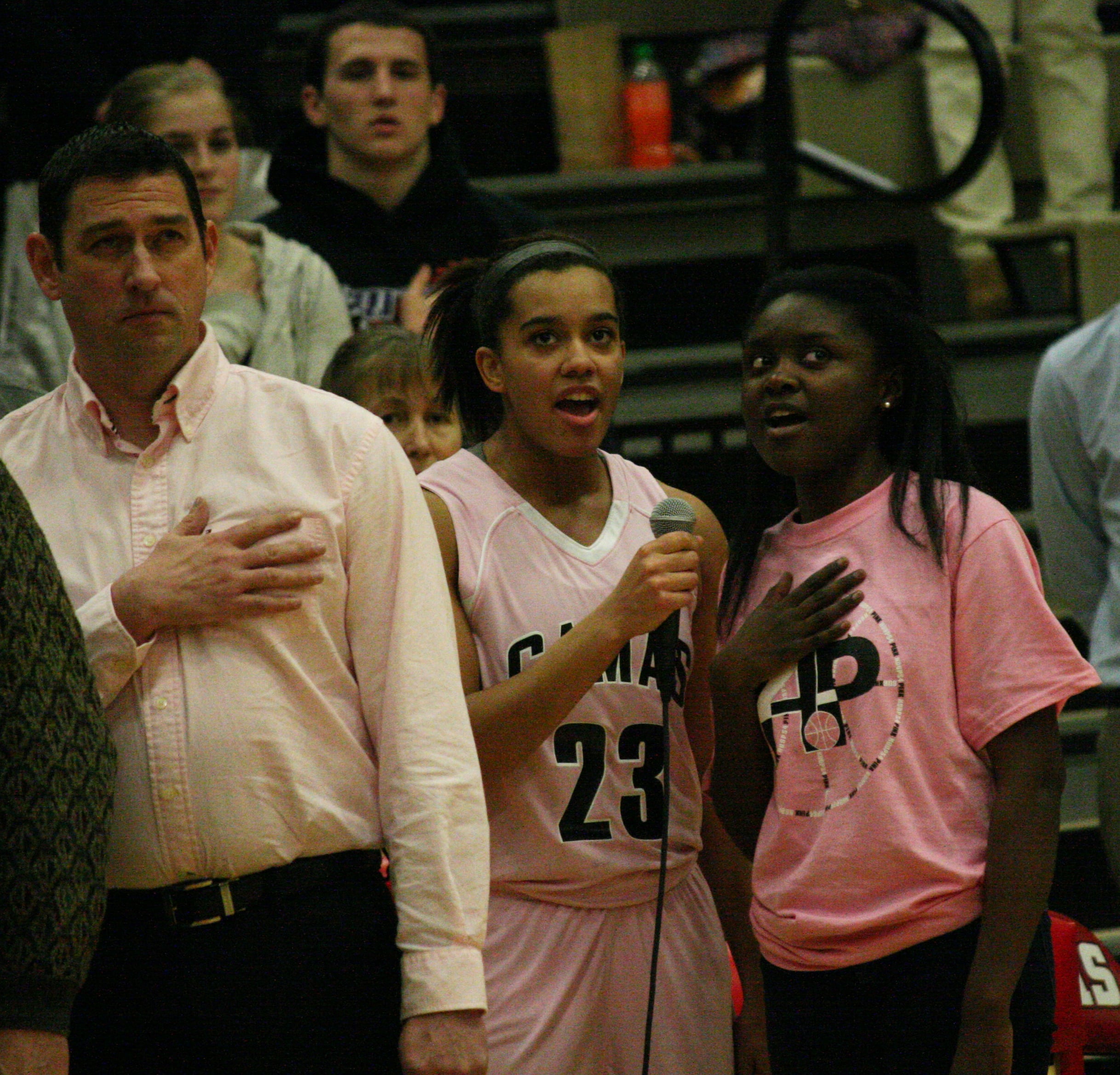 Rachel Gray and Amanda Lubanga sing the National Anthem.
