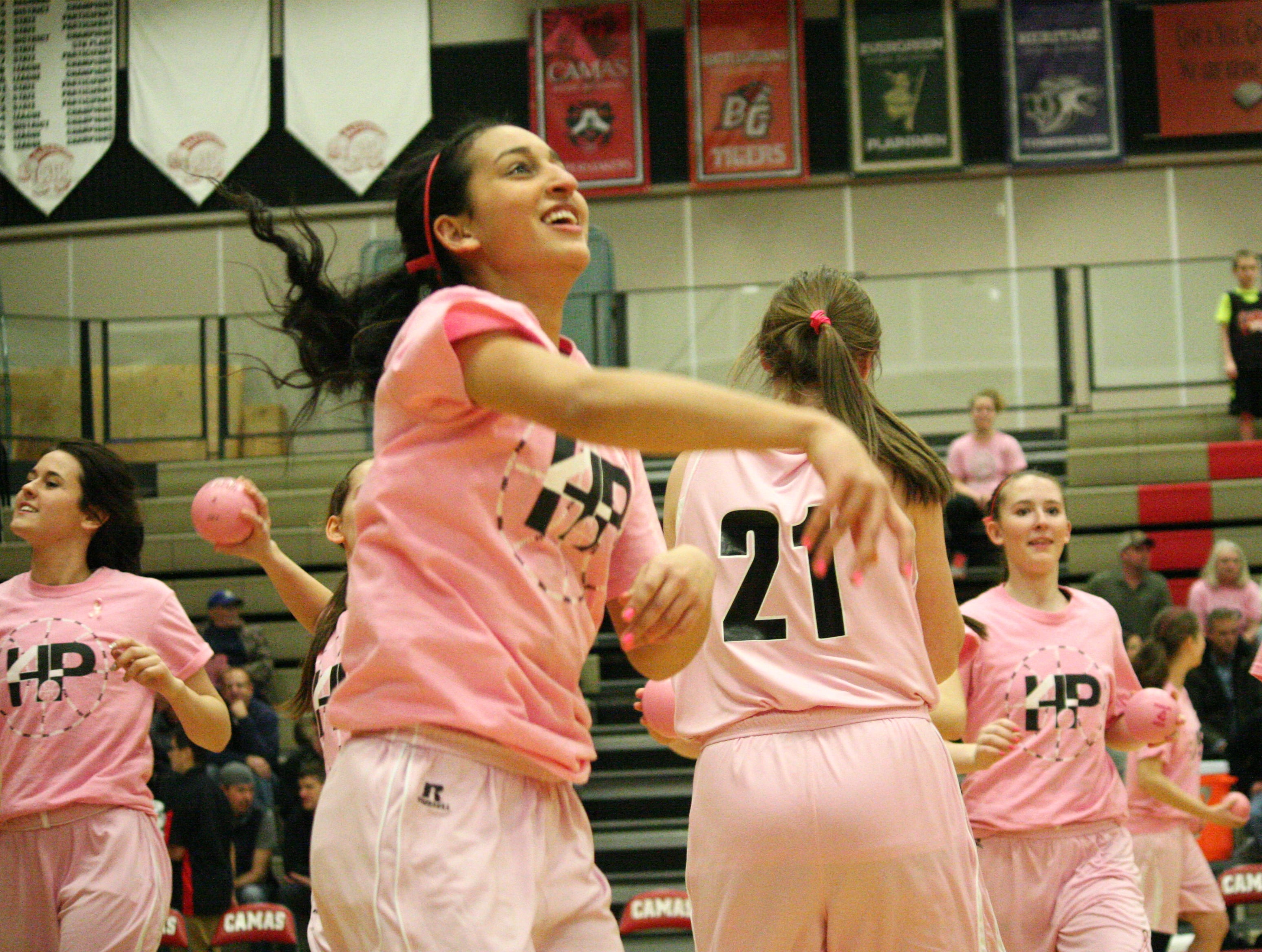 Papermakers toss pink basketballs into the crowd.