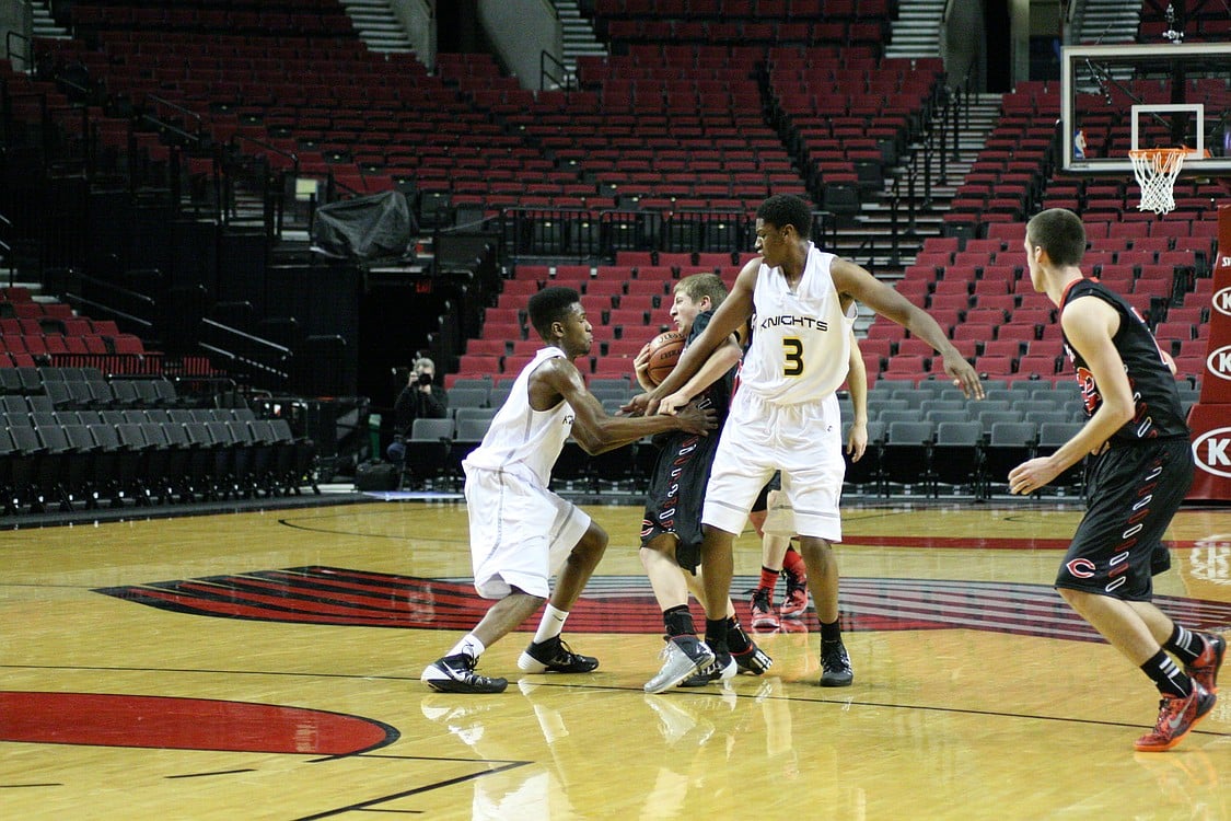 Jake Hansel fights for possession of the basketball.
