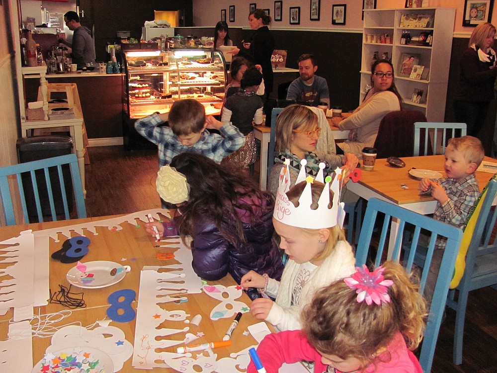 Children enjoyed decorating paper crowns and butterfly-shaped face masks, at a "New Year's at Noon" celebration, Wednesday, at Cake Happy. The bakery and coffee shop opened in downtown Camas, in October 2014.
