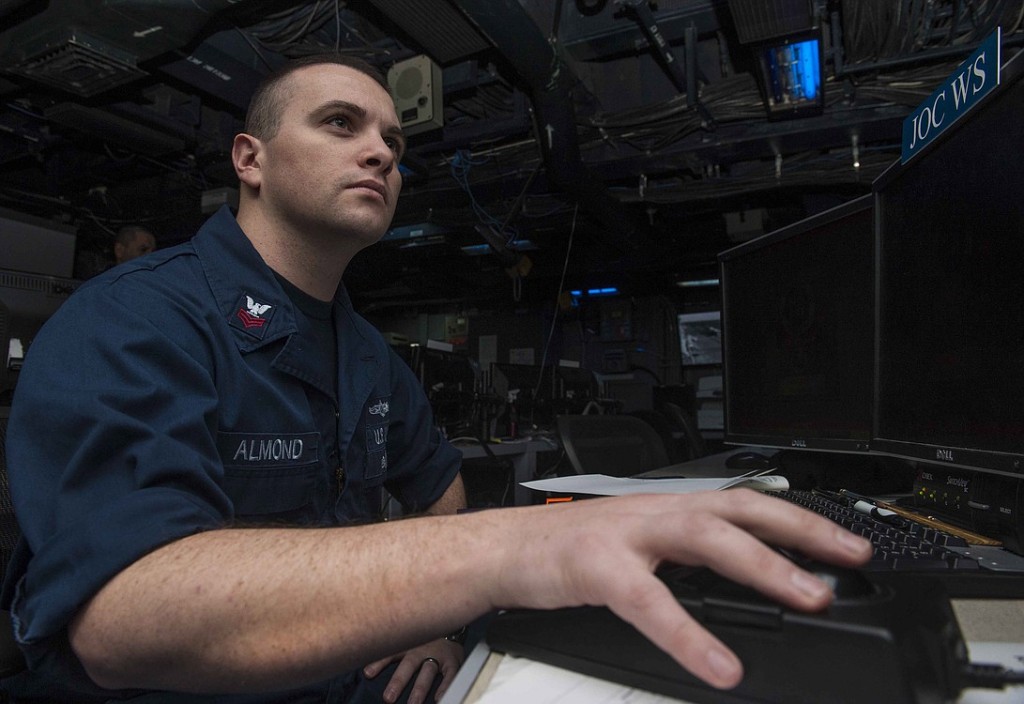 Almond stands watch in the Joint Operations Center aboard the amphibious assault ship USS Boxer, the flagship for the Boxer Amphibious Ready Group.