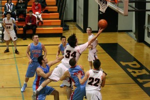 Washougal High School senior Aaron Deister splits the defense and scores a basket Thursday, at WHS. The Panthers defeated the Monarchs 66-58. See the photo gallery at www.camaspostrecord.com.