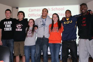 Camas High School seniors Austin Barr, Michael Koceja, Emily Ainsworth, Jonathan Warner, Olivia Lovell, John Payne and Kamari Brown (left to right) smile for the camera on National College Signing Day.