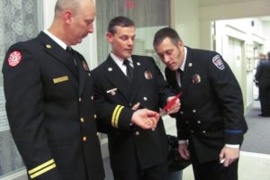 Camas Fire Department Battalion Chief Mark Ervin, Firefighter/Paramedic Kevin Wilson and Firefighter/Paramedic Chris Richardson (from left to right) look over the program for the annual awards banquet Friday night, at the Camas Community Center. The event honored paid Camas and Washougal firefighters, as well as retired Camas volunteer firefighters and their spouses.