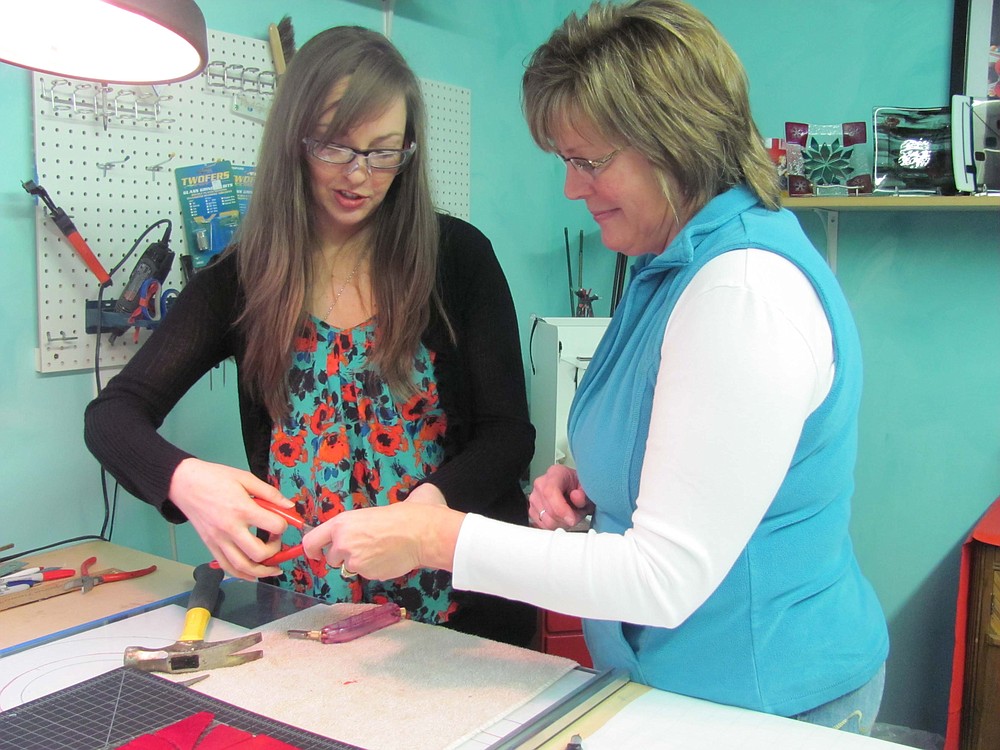 Bishop (right) assists Bosckis with a project during a recent class. "The classes are fun and no creativity is required," Bishop said.