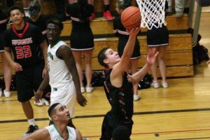 Jordan Anderson lays the ball into the basket for the Papermakers during Saturday's state regional playoff game against Kentwood, at Puyallup High School. Camas rallied from 13 points down at halftime, but Kentwood won the game 55-53.