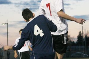 Tyler Vela heads the ball forward for the Camas High School soccer team Monday, at Doc Harris Stadium. The Papermakers beat Hockinson 3-0.