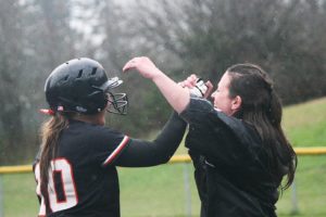 Washougal softball coach Heather Carver congratulates Madisen Baldwin after she ripped the RBI double that propelled the Panthers to a 7-2 victory March 17.