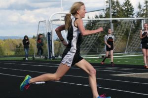 Courtney Owens kicks to the finish line for Washougal Thursday, at Ridgefield High School. The sophomore ran the school's third fastest girls mile time of 5:32.49.