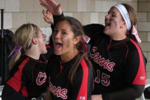 Lena Richards celebrates with teammates Emma Jimenez and Katie Schroeder after scoring the tying run Saturday, at Sandy High School. The game would go eight innings before the Papermakers defeated the 2013 Oregon 5A state champions 3-2.