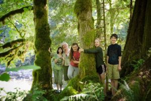 TreeSong founder Michelle Baumann and four children immerse themselves in a "community circle" of trees by the Washougal River.