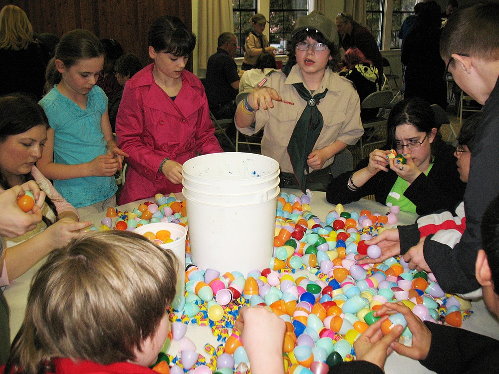 Members of Boy Scout 562, along with volunteers from the Washington School for the Blind, stuff Easter eggs a few days before the Camas Parks and Recreation hunt. It takes the 67 volunteers approximately an hour to stuff all 10,000 eggs.