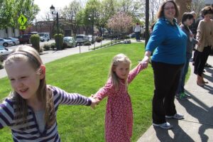 Patrons of all ages gathered April 17, to "hug" the Camas Public Library, in celebration of its 90th birthday. Ninety people took part and sang "Happy Birthday." On Saturday, there will be an all-day celebration at the library, which will include tours, balloon animals and children's crafts.