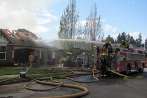 Approximately 25 personnel on nine units from the Camas-Washougal Fire Department, Vancouver Fire Department and East County Fire and Rescue, were at the scene of the fully involved house fire. One of the C-W firefighters was treated for a minor injury and released from PeaceHealth Southwest Medical Center, in Vancouver. Camas police officers also responded, to enforce road closures and detours.