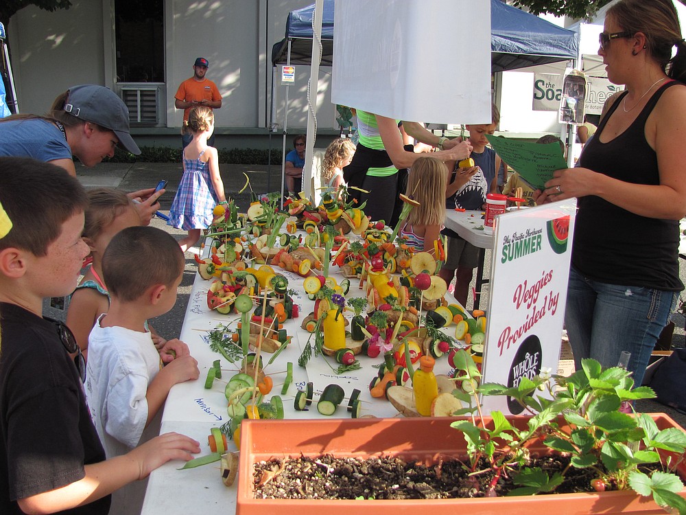 Kids give their creations one final inspection before the Veggie Derby. Awards are given out for most use of veggies, farthest/fastest and most creative.