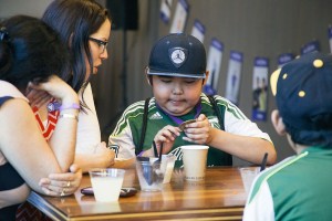 Joevanni Hernandez, 12, looks at a medal he received from Children's Cancer Association, of Portland. He was among 12 honorees at a May 26 ceremony at OMSI. Hernandez, of Washougal, has aplastic anemia.