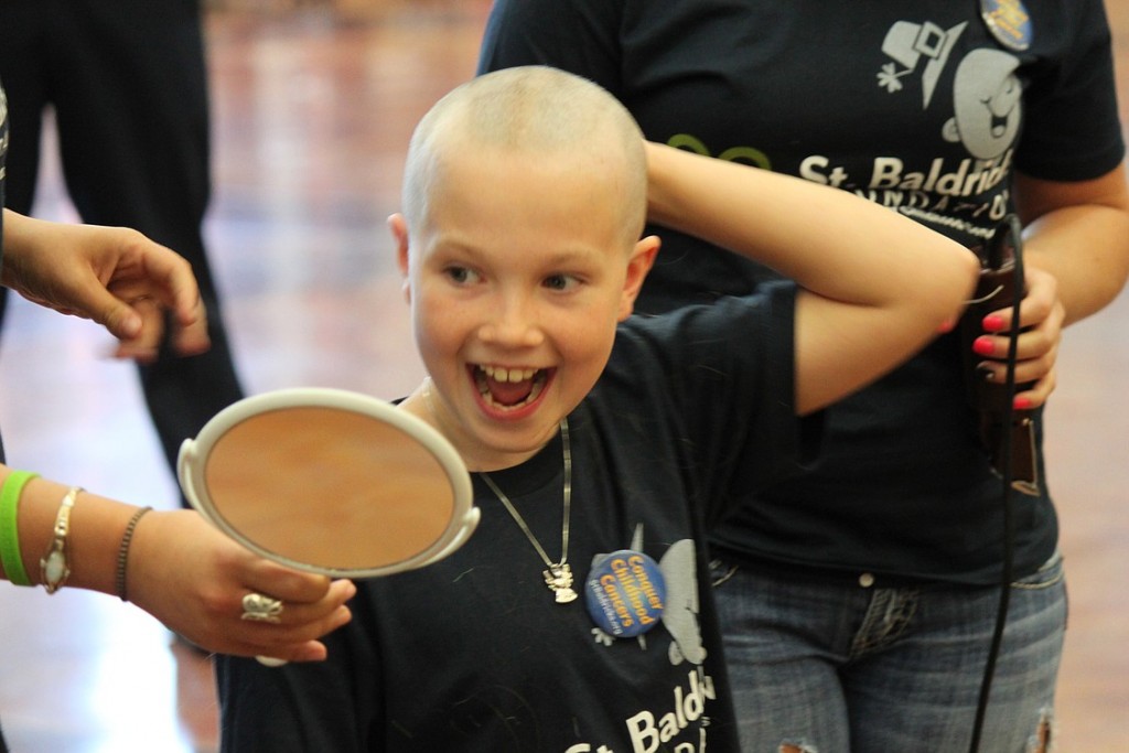 Mederos takes a look at her newly shaven head on Sunday. She donated her hair to Locks of Love.