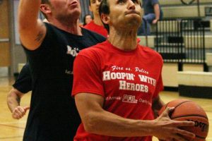 Firefighter Matt Baldwin gets by police officer Colton Price on a fast break during the Camas-Washougal Fire vs. Police charity basketball game. The fire department made a big push late in the game, but the police held on for a 65-58 victory.