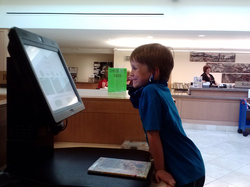 A summer reading participant checks out a book from the Camas Public Library. The summer reading program runs until Aug. 10.