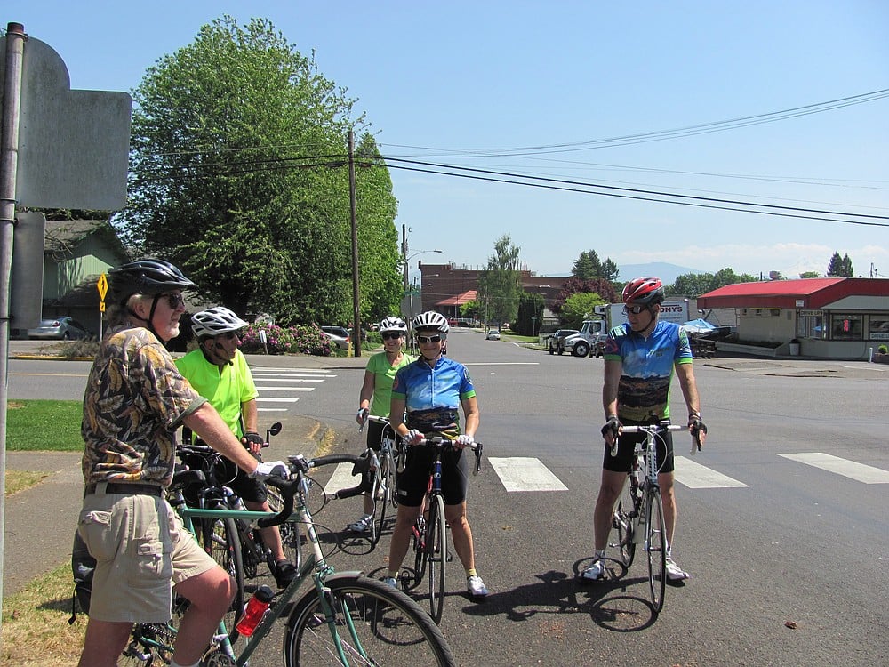 Cyclists stop near a historical house, one of the points of interest during Joseph Blanco's history rides in Camas. Cycling is becoming an increasingly popular way to spend leisure time, but it is still developing as a lifestyle.