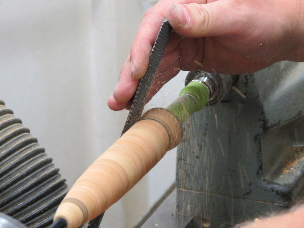 Ryan Lee shapes the handle of a C.F. Burkheimer fly rod.