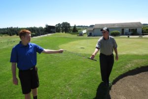 Connor Coombs hands a sand wedge to his father. Green Mountain golf course general manager Kevin Coombs is going to play in the U.S. Senior Open Thursday, July 11, at Ohama (Neb.) Country Club. His son, Connor, will be his caddy.