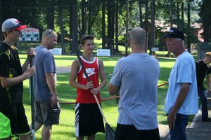 Camas-Washougal Babe Ruth baseball players, coaches and board members rake, trim and water the field at Louis Bloch Park to get it ready for the 13-year-old state tournament.