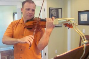 Matt Mandrones practices playing his violin at home in Camas. He said there is a poster of Einstein in his studio, because the physicist was a deep thinker and he played the violin. Mandrones is a member of several orchestras in the region. He is a string orchestra teacher with the Evergreen School District and is also available to teach private violin lessons. In addition to playing at concerts, weddings and church services, Mandrones performs as a strolling violinist at restaurants and retirement/assisted living facilities.