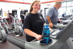 Mary McFarland of Camas (left) and Ron Winders of Washougal (right) build strength and endurance on the treadmills at SNAP Fitness in Camas. McFarland was born with a brain defect and had her hip replaced at the age of 13. Winders, 62, is going in for knee replacement surgery. He hopes for a speedy recovery so he can get back in the gym.