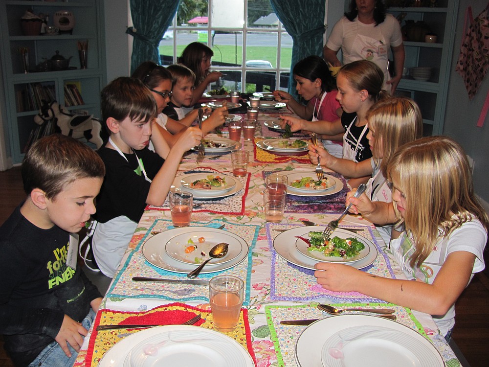 Danielle Frost/Post-Record
The young chefs say grace before they enjoy a meal everyone helped prepare.