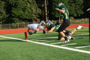 Zach Eagle dives across the goal line to score a 38-yard touchdown interception for Camas Friday, at McKenzie Stadium. The Papermakers rolled over Evergreen 62-15.