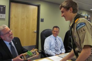 Shane Southerland presents an benthic bug display rack, created from Western Red Cedar, to Camas School District Superintendent Mike Nerland.