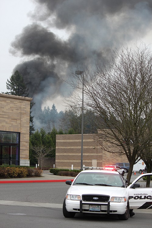 Smoke billowed from the scene of a house fire and shooting at 3275 F Place in Washougal. There were two explosions, with at least one being caused by a propane tank.