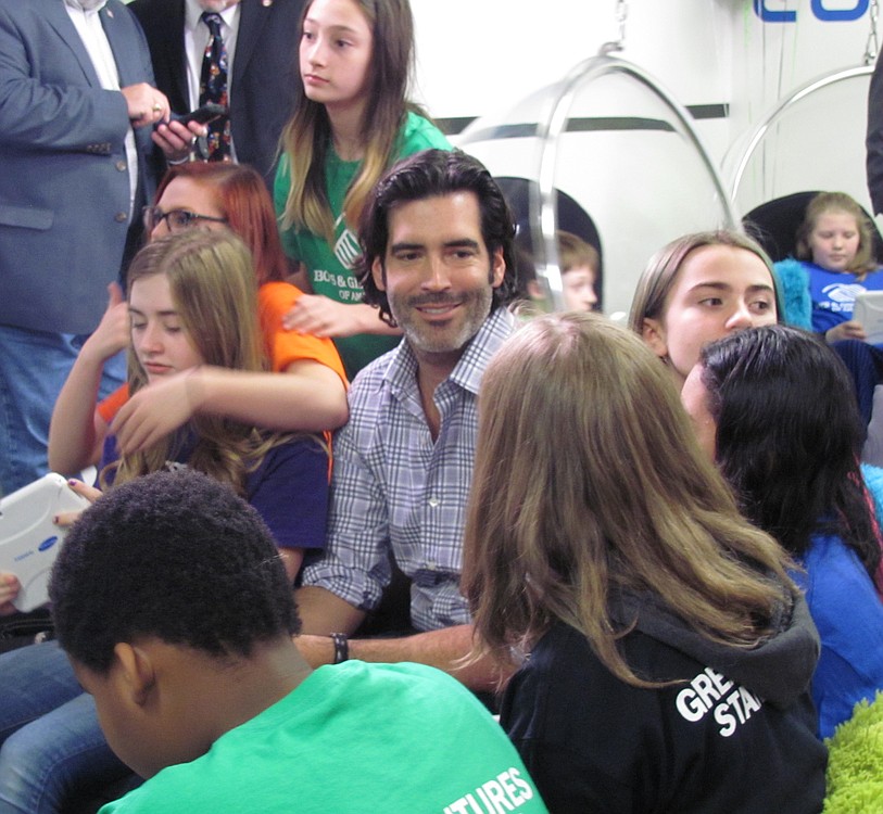 Carter Oosterhouse chats with middle schoolers during the new tween tech center's "big reveal" party at the Jack, Will and Rob Boys & Girls Club.