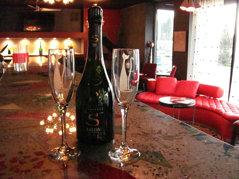 Souvenir champagne flutes, with the etched "Kool Kat" logo, are available to purchase. The top of the bar, which includes broken glass images of bubbles coming out of champagne flutes, was designed by Krystal Curtis, her mother Carol Curtis and champagne server Ashley Gibson. Scott McElhaney and champagne server Pete Scully poured the epoxy.