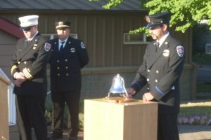 Cliff Free, division chief of emergency medical services with the Camas-Washougal Fire Department, pauses as Firefighter/Paramedic Ben Silva rings a bell and retired Fire Capt. Larry Saari looks on in front of C-W Fire Station 171, in Washougal, Wednesday morning. The tribute to the thousands of people who died as the result of terrorists' acts Sept. 11, 2001 included comments from Free, Saari, Fire Chief Nick Swinhart and Washougal Mayor Sean Guard. "Twelve years ago, a horrible act happened to our great nation," Saari said. "Today we will have time to think about all those who were lost, far too early in life and of the heroes who did what they had to do to save so many lives." Trumpet player Isaac Hodapp, a sophomore at Camas High School, performed "Taps." After the ceremony, a complimentary breakfast was provided by members of the East Clark Professional Firefighters. Saari and staff members placed more than 300 small American flags along the entryway to the fire station Tuesday. The streets of downtown Camas and Washougal were also lined with flags installed by members of the Veterans of Foreign Wars Schick-Ogle Post 4278.