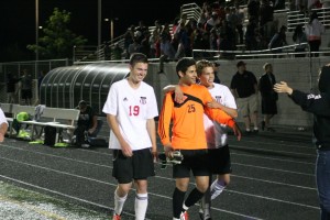 Camas soccer seniors Houston Taie (right) and Matt Rose (left) celebrate with goalkeeper Sharif Batroukh (middle) after Batroukh blocked the last shot in a shootout with Skyline Tuesday, at Doc Harris Stadium. The win propels the Papermakers into the quarterfinal round of their first 4A state tournament.