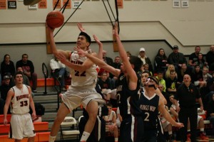 Austin Tran threads the needle around the Knights and weaves a basket for the Panthers Monday, at Washougal High School. The Panther boys and girls teams swept King's Way Christian in a doubleheader.