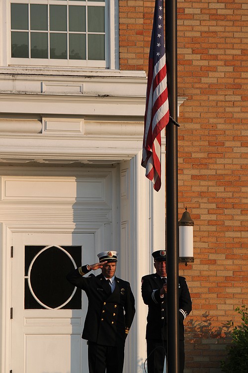 Camas Battalion Chief Allen Wolk (left) and Fire Capt. Chuck Bettis (right) raised the flag at the library to half-mast. In addition to members of the Camas Fire Department, Sundays event included members of the Veterans of Foreign Wars Camas-Washougal Post 4278. Organizer Camas Firefighter/Paramedic Chris Richardson said Washougal Fire Department personnel staffed local stations so that CFD employees could participate in the memorial.