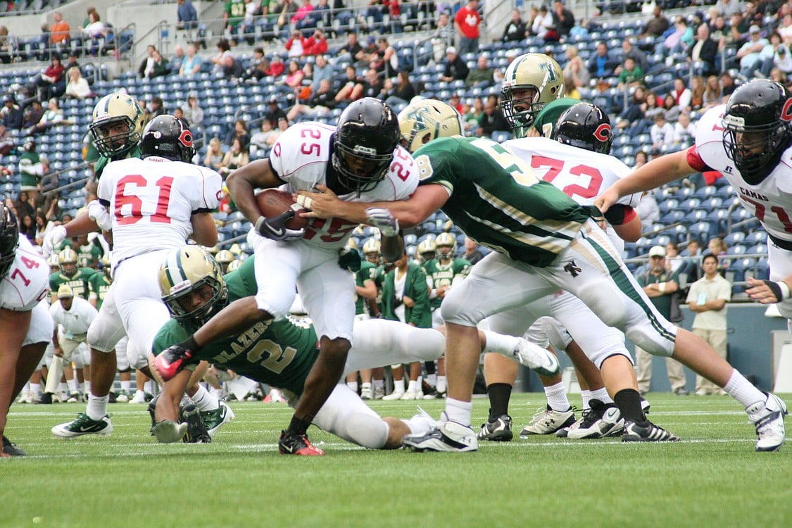 Zack Marshall blasts through the Timberline wall of defense to score his second of three touchdowns for Camas.