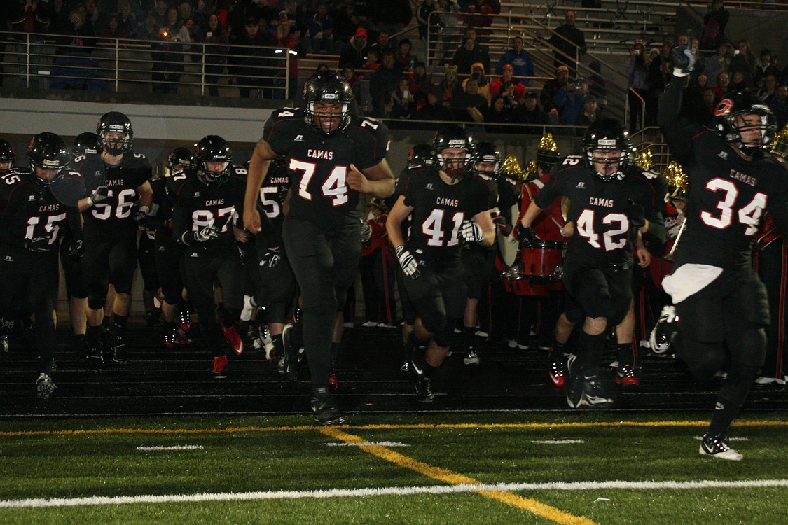 The Camas football players make a push for their first state playoff victory in school history Nov. 13, at Doc Harris Stadium.