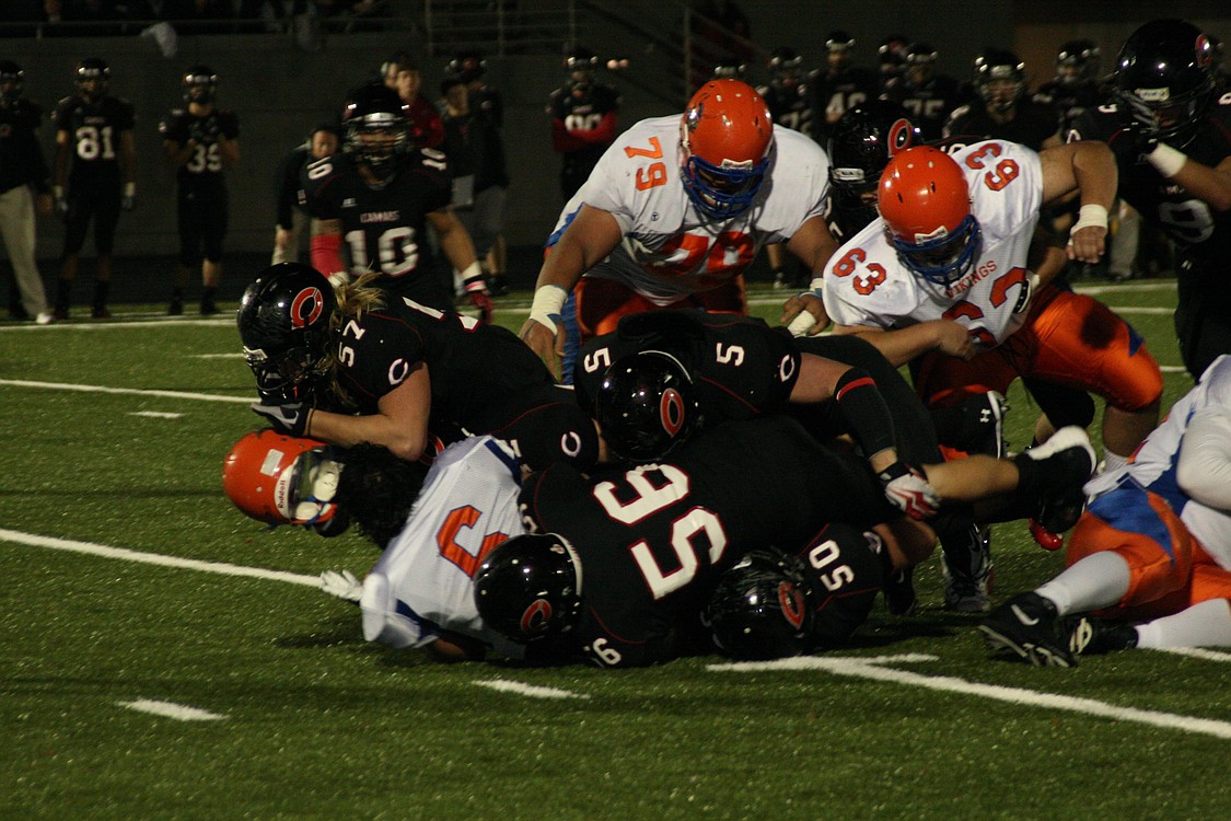 Odin Coe (57) and the bull dozing Camas defeders take Rainer Beach's heads off Nov. 5, at Doc Harris Stadium.