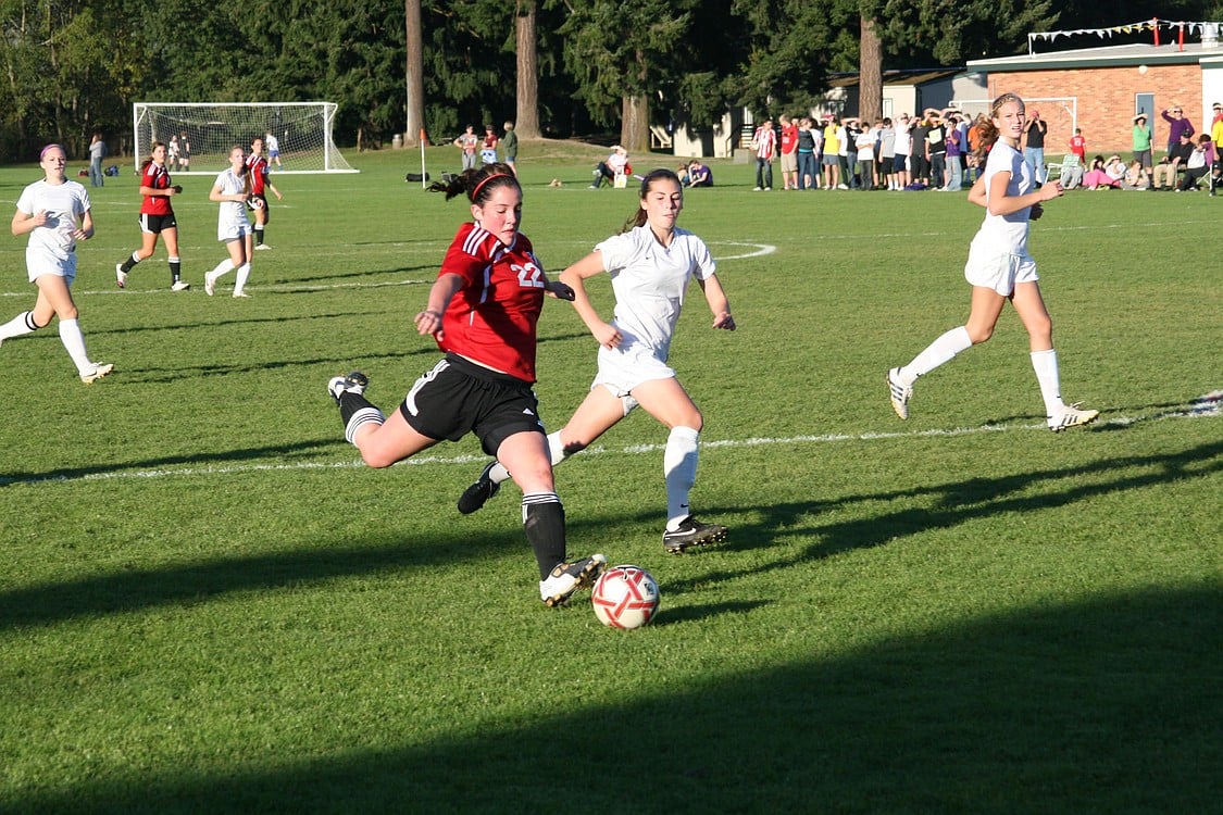 Janae Benson blasts the soccer ball at the net for the Camas High School girls soccer team Oct. 19, against Columbia River.